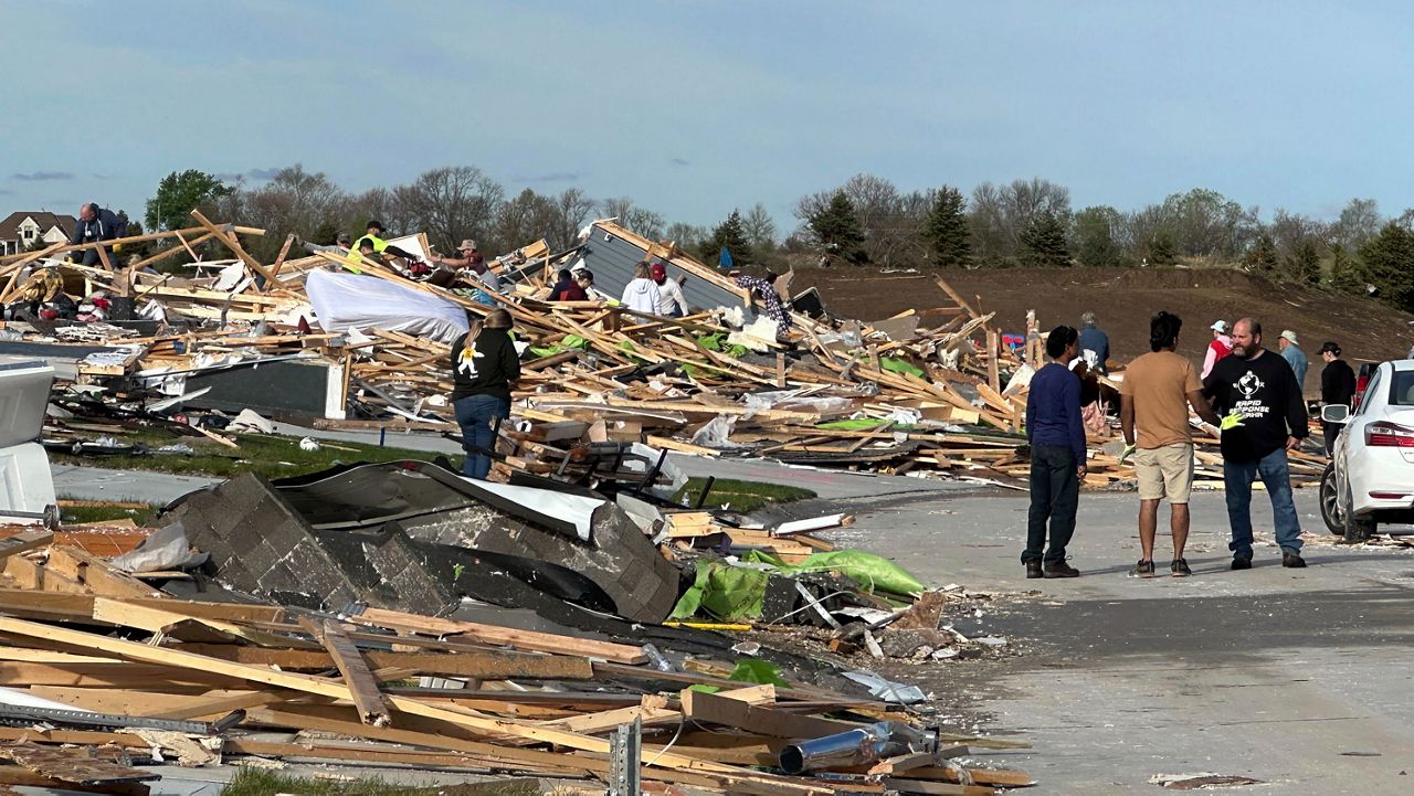 People pick through the rubble of a house that was leveled in Elkhorn, Neb., on Saturday, April 27, 2024. Residents began sifting through the rubble after a tornado plowed through suburban Omaha, demolishing homes and businesses as it moved for miles through farmland and into subdivisions. (AP Photo/Nick Ingram)