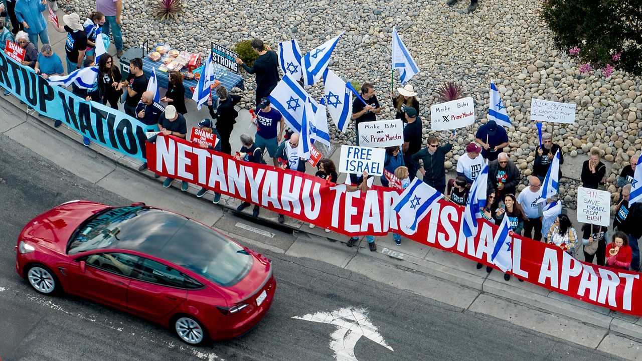 Protesters rally outside Tesla's Fremont, Calif., factory ahead of Israeli Prime Minister Benjamin Netanyahu's visit with businessman Elon Musk on Monday, Sept. 18, 2023. (AP Photo/Noah Berger)