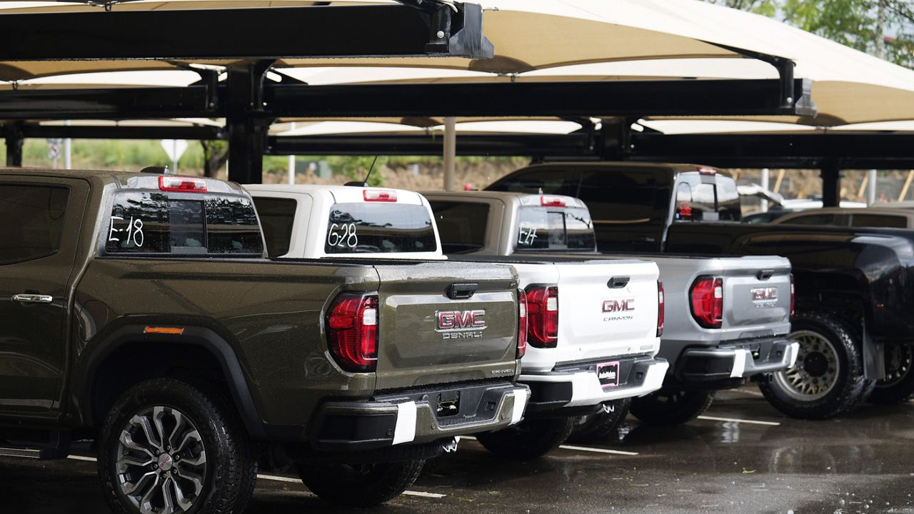 Unsold 2023 Sierra pickup trucks sit in a lot at a GMC Truck dealership Thursday, June 22, 2023, in Lone Tree, Colo. (AP Photo/David Zalubowski)