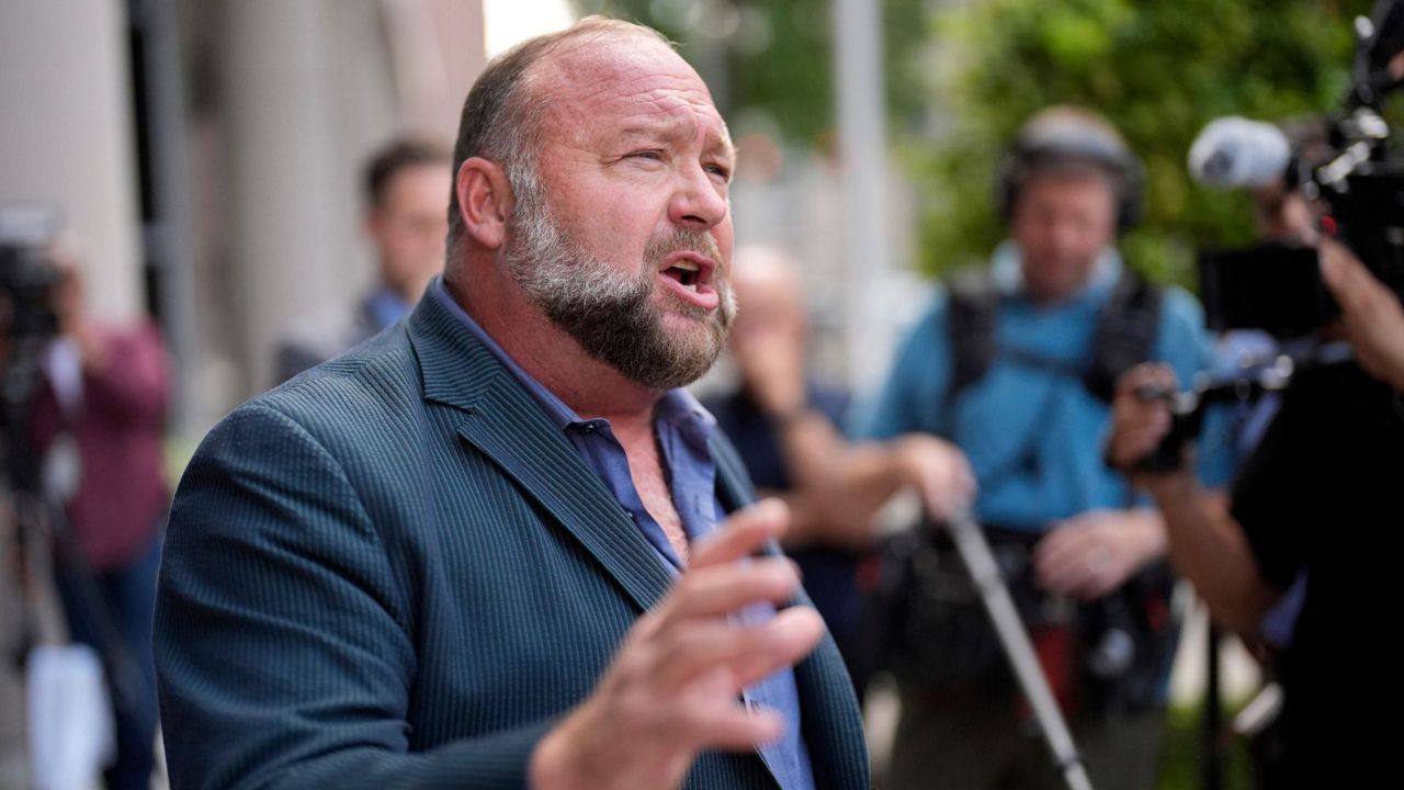 Right-wing conspiracy theorist Alex Jones speaks to the media after arriving at the federal courthouse for a hearing in front of a bankruptcy judge, Friday, June 14, 2024, in Houston. (AP Photo/David J. Phillip, File)