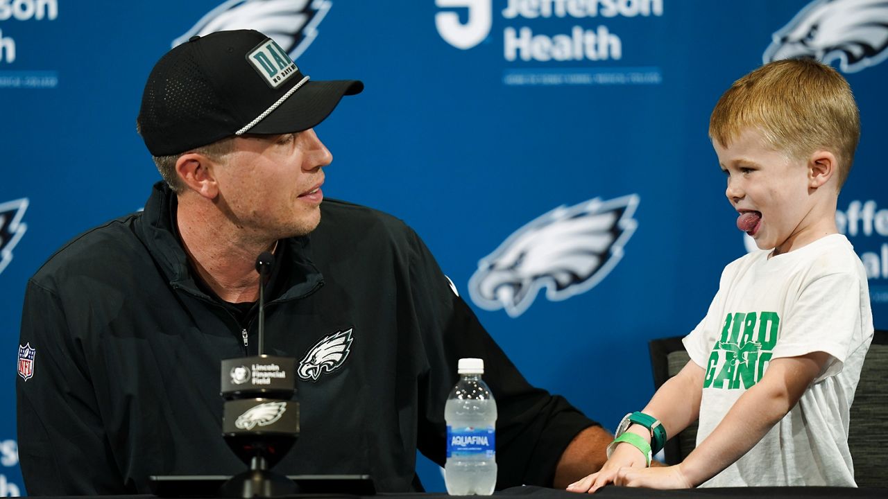 Former Philadelphia Eagles quarterback Nick Foles attends his retirement news conference with his son Duke before an NFL football game between the Eagles and the Atlanta Falcons on Monday, Sept. 16, 2024, in Philadelphia. (AP Photo/Chris Szagola)