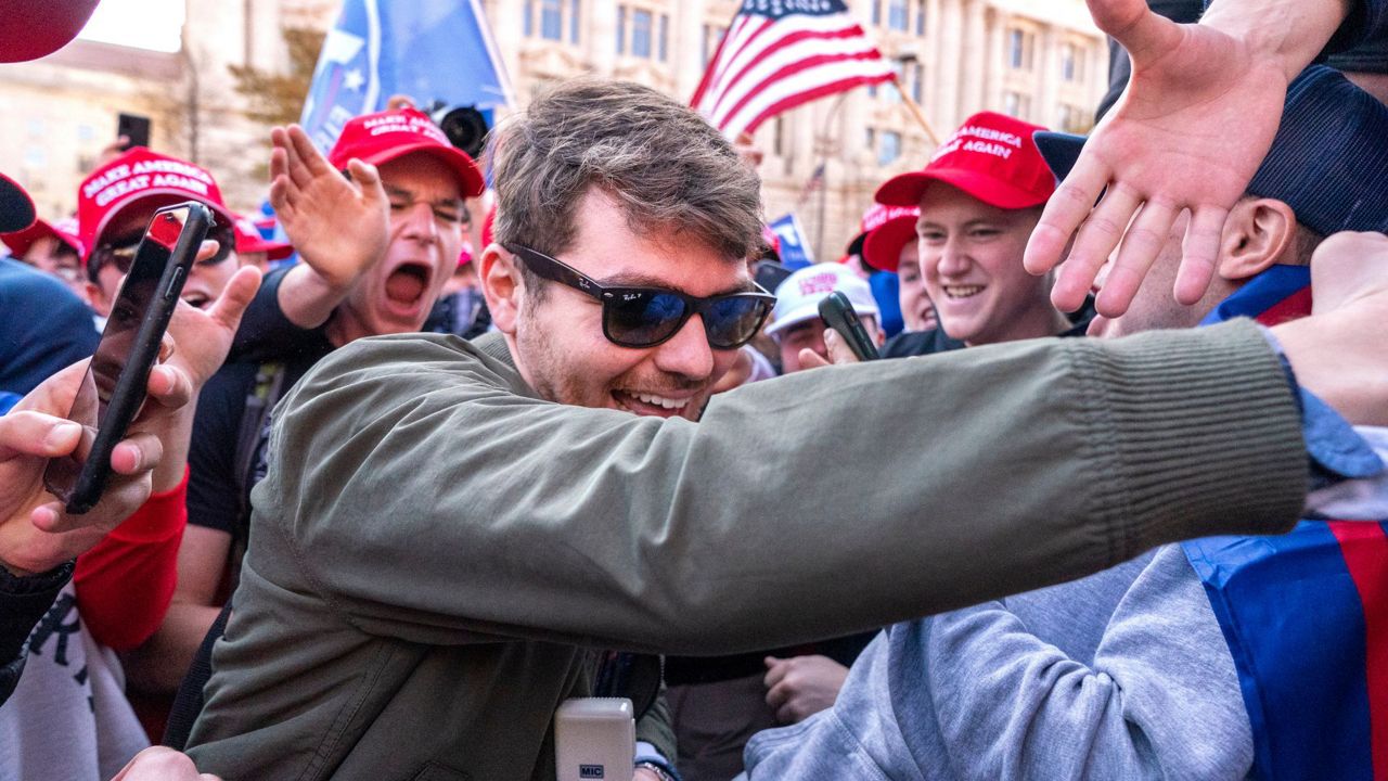 Nick Fuentes right-wing podcaster, center, greets supporters before speaking at a pro-Trump march, Nov. 14, 2020, in Washington. (AP Photo/Jacquelyn Martin, File)