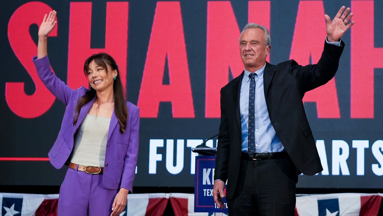Presidential candidate Robert F. Kennedy Jr. right, waves on stage with Nicole Shanahan, after announcing her as his running mate, during a campaign event, Tuesday, March 26, 2024, in Oakland, Calif. (AP Photo/Eric Risberg)