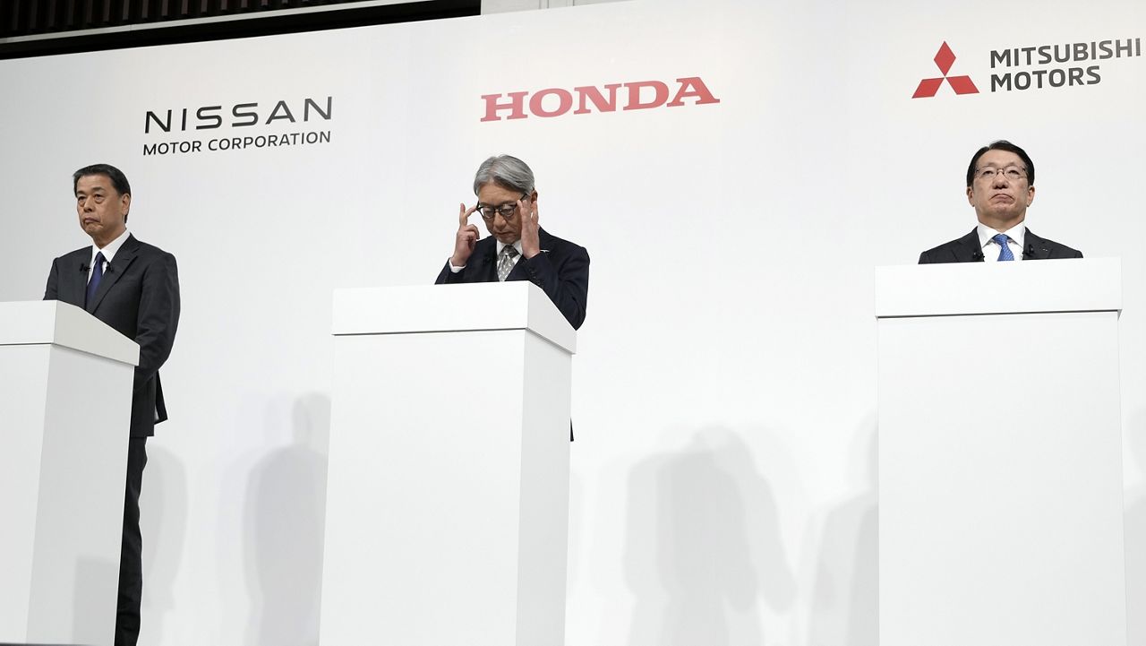 Nissan Chief Executive Makoto Uchida, left, and Honda Chief Executive Toshihiro Mibe, center, and Takao Kato CEO of Mitsubishi Motors, right, attend a joint news conference Monday, Dec. 23, 2024, in Tokyo, Japan. (AP Photo/Eugene Hoshiko)