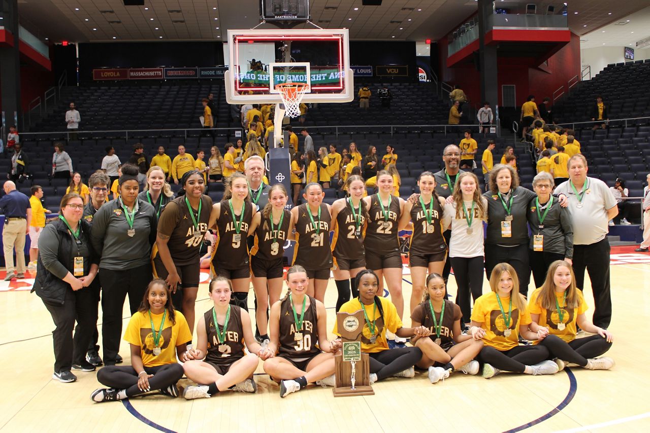 The Kettering Archbishop Alter High School girls basketball team stands together with the state runners-up trophy after the OHSAA Girls State Championship at UD Arena on Friday.