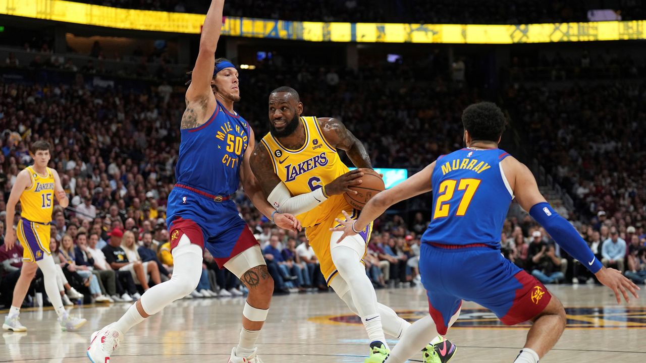 Los Angeles Lakers forward LeBron James (6) drives as Denver Nuggets forward Aaron Gordon (50) and guard Jamal Murray (27) defend during the first half of Game 1 of the NBA basketball Western Conference Finals series, Tuesday, May 16, 2023, in Denver. (AP Photo/Jack Dempsey)