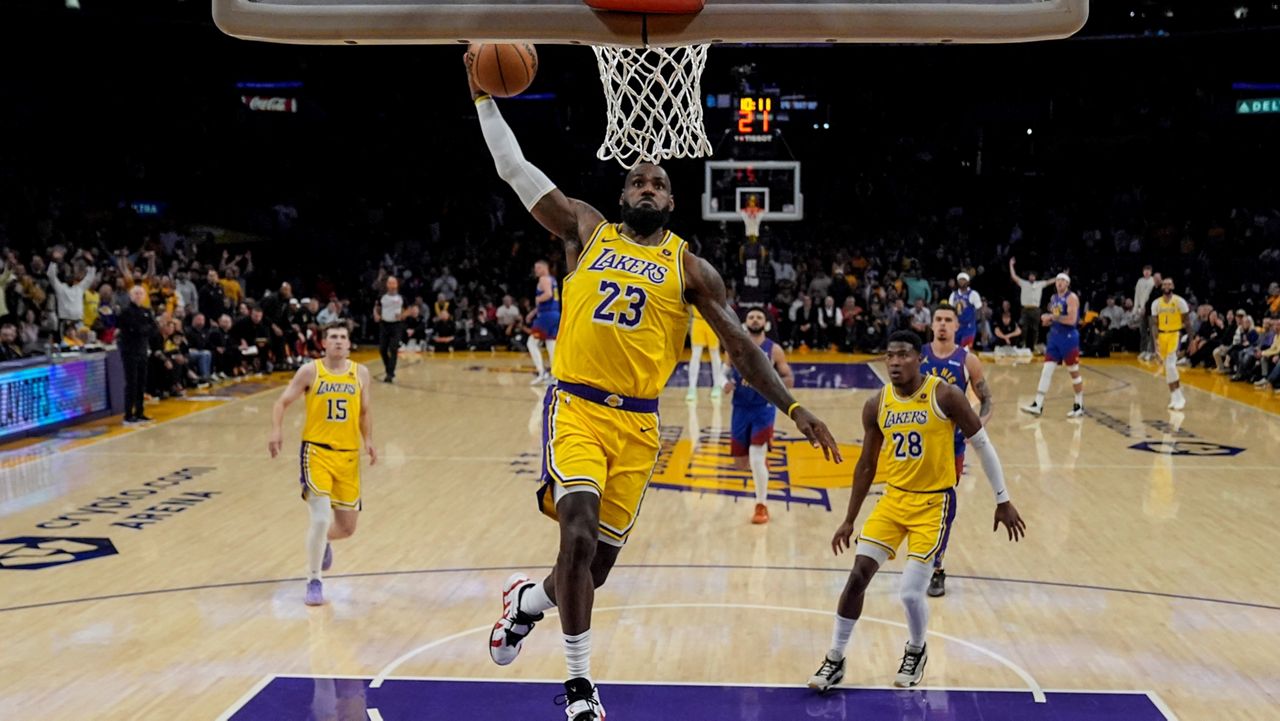 Los Angeles Lakers forward LeBron James (23) dunks during the first half of Game 3 of an NBA basketball first-round playoff series against the Denver Nuggets in Los Angeles, Thursday, April 25, 2024. (AP Photo/Ashley Landis)