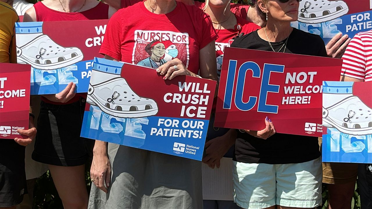 Maine Medical Center nurses hold up anti-ICE signs during a public rally celebrating the release of MMC Nurse Deborah Kapisha from ICE custody on Thursday. (Spectrum News/Sean Murphy)