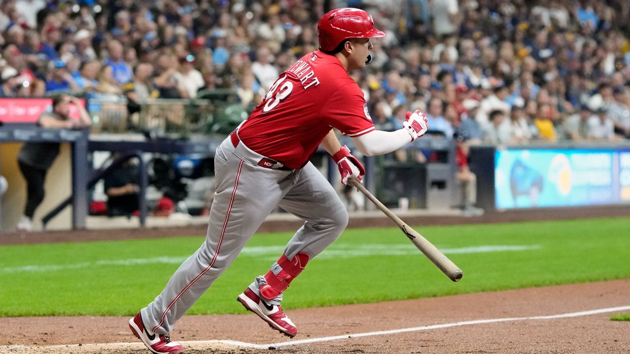 Reds on cusp of playoff berth after beating Brewers 7-4