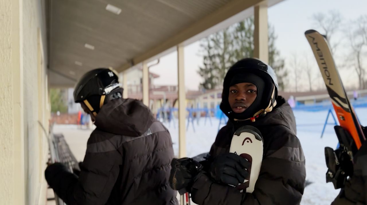 Refugees get to experience snowboarding and skiing in Ohio