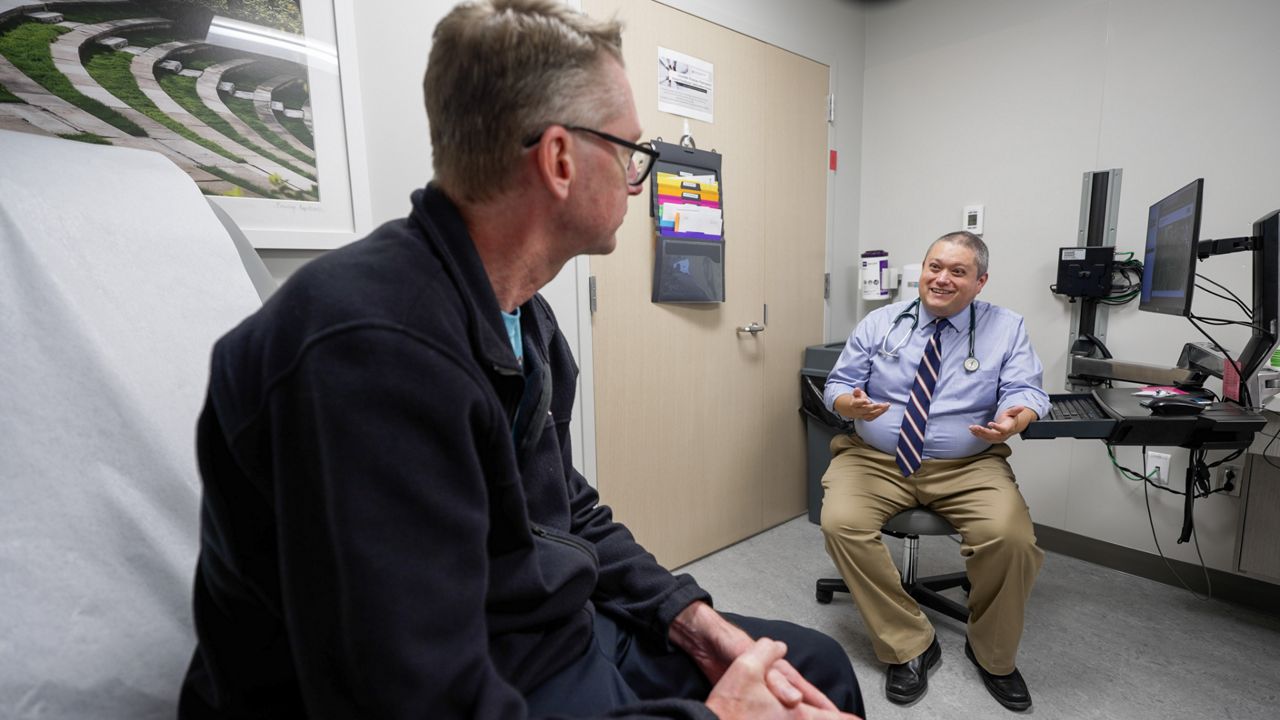 Dr. Harrison Jackson (right) participated in a pilot program for an application called Microsoft Dragon Ambient eXperience Copilot, which listens to the conversation between physician and patient (securely) and provides clinical notes.