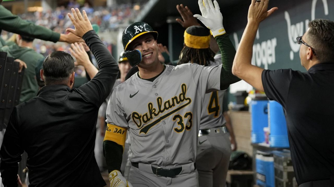 Oakland Athletics' JJ Bleday (33) celebrates his three-run home run against the Texas Rangers in the third inning of a baseball game, Friday, Aug. 30, 2024, in Arlington, Texas. (AP Photo/Tony Gutierrez)