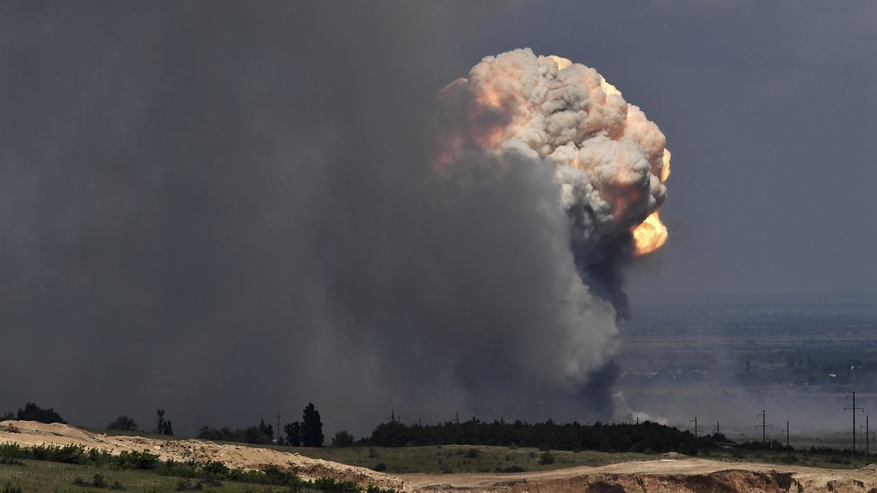 A plume of smoke rises over an ammunition depot where explosions occurred at the facility in Kirovsky district in Crimea, Wednesday, July 19, 2023. (Viktor Korotayev/Kommersant Publishing House via AP)