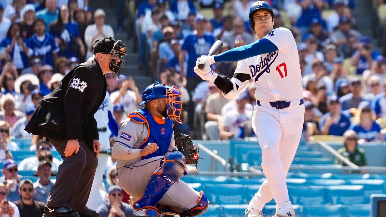 Los Angeles Dodgers designated hitter Shohei Ohtani (17) swings a strike during the sixth inning of a baseball game against the New York Mets in Los Angeles, Saturday, April 20, 2024. (AP Photo/Ashley Landis)