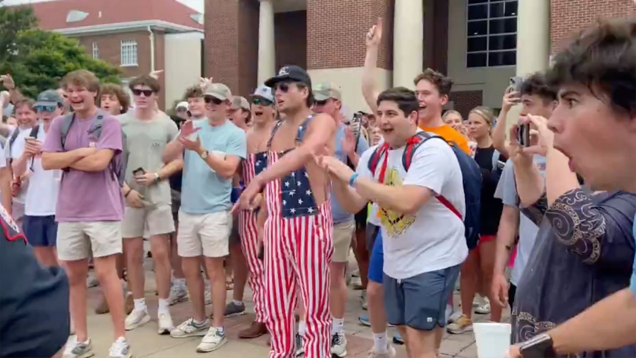 In this photo taken from video provided by Stacey J. Spiehler, hecklers shout at a pro-Palestinian protester at the University of Mississippi, Thursday, May 2, 2024, in Oxford, Miss. The hecklers vastly outnumbered pro-Palestine demonstrators and video shot by a student journalist showed one white heckler making monkey gestures and noises at a Black woman who was supporting pro-Palestinian protesters. (Stacey J. Spiehler via AP)