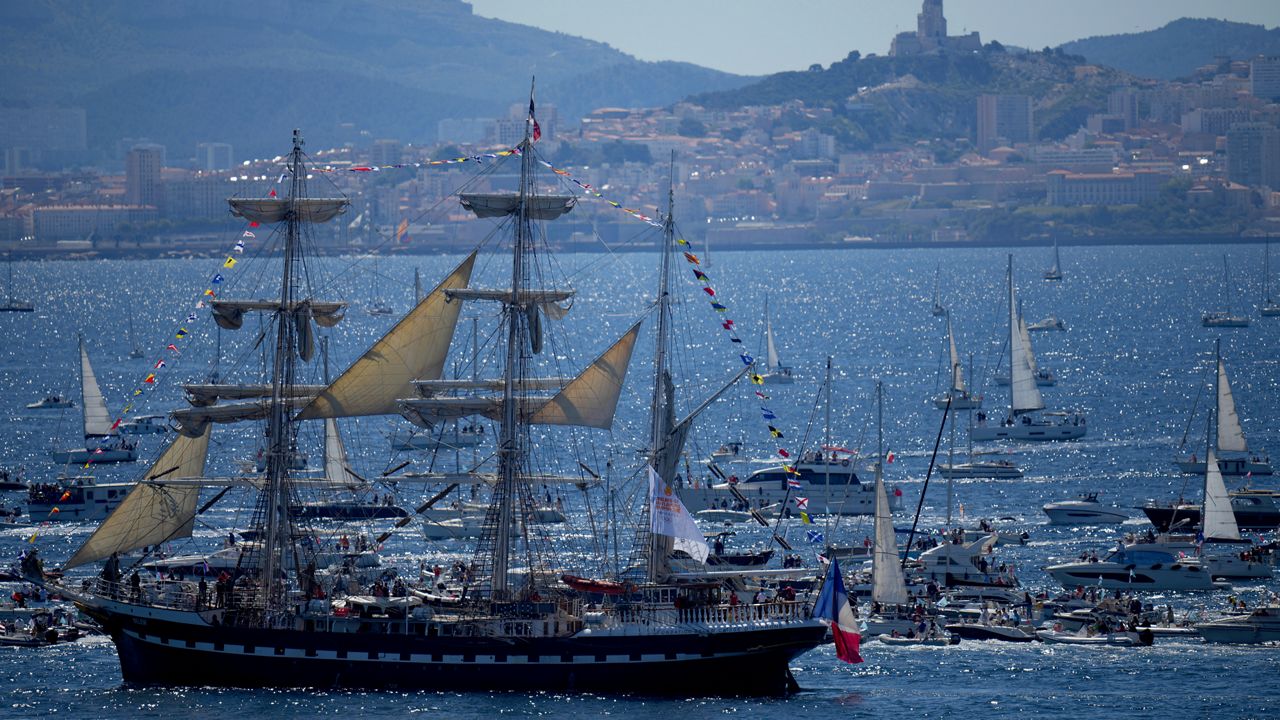 The Belem, the three-masted sailing ship which is carrying the Olympic flame, is accompanied by other boats approaching Marseille, southern France, Wednesday, May 8, 2024. After leaving Marseille, a vast relay route is undertaken before the torch odyssey ends on July 27 in Paris. The Paris 2024 Olympic Games will run from July 26 to Aug.11, 2024. (AP Photo/Daniel Cole)