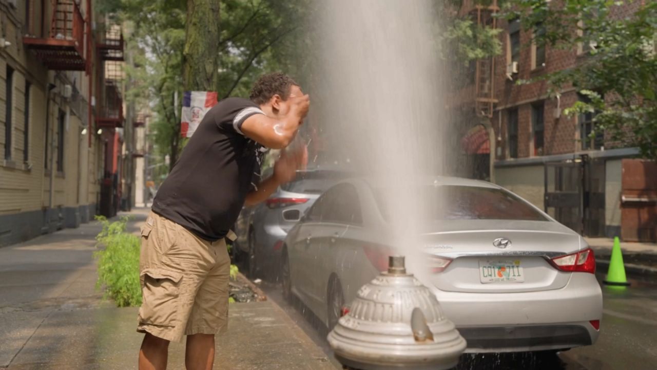 Is it safe to cool off under an open fire hydrant?