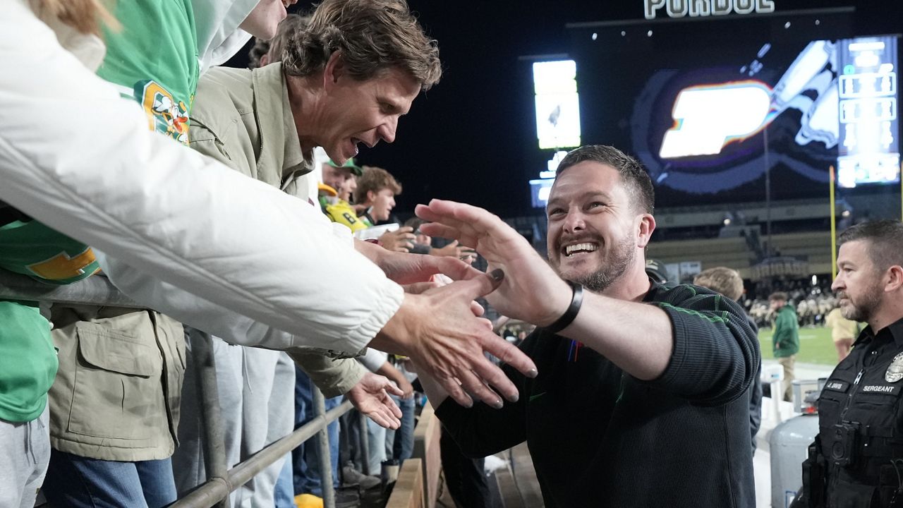 Oregon head coach Dan Lanning celebrates with fans after his team defeated Purdue in an NCAA college football game in West Lafayette, Ind., Friday, Oct. 18, 2024. (AP Photo/AJ Mast)