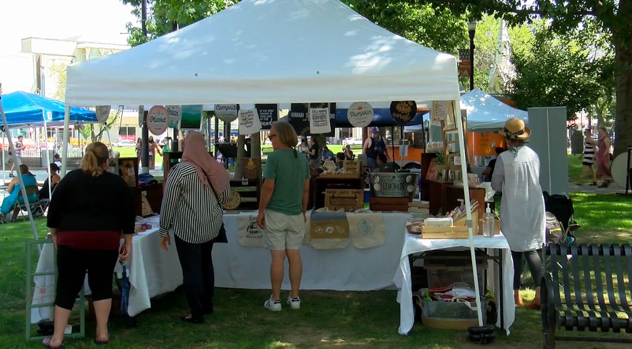 Shoppers check out a local vendor at the Out to Lunch festival. (Spectrum News 1)