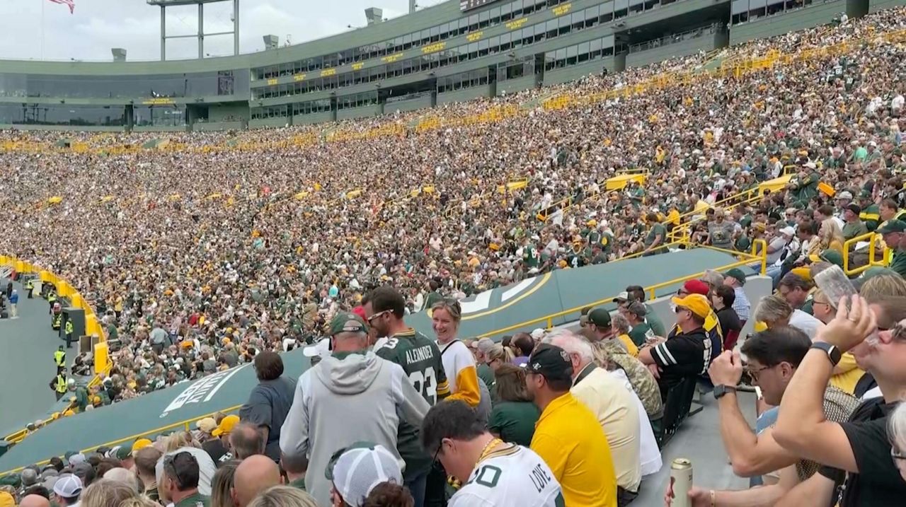 Fans tailgate outside Lambeau Field before an NFL football game between the Green  Bay Packers a …