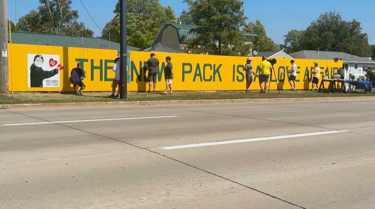 Family and friends honor Packers fan by painting new slogan on historical  fence