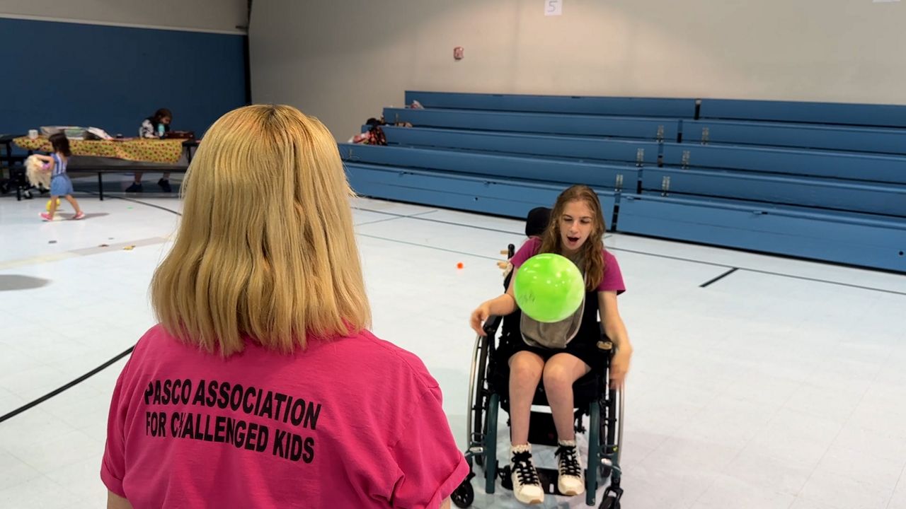 P.A.C.K. founder Paula Cohen plays with campers at P.A.C.K. Camp. (Spectrum News/Tim Wronka)