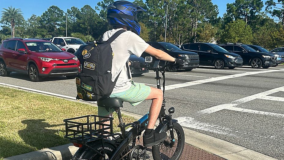 Skyler Scott says he loves his e-bike, but because he is aware of the dangers, he makes sure to obey all traffic laws and always wears a helmet and gloves. (Spectrum News/Brandon Spencer)