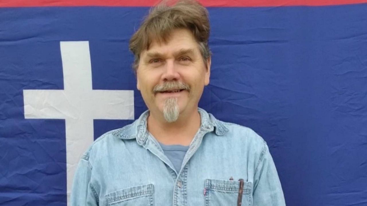 Darrell McClanahan of Milo, a candidate for governor who the Missouri Republican Party attempted to remove from the ballot for being an ‘honorary’ KKK member. He is shown in a photo from his 2022 campaign for U.S. Senate, standing in front of the flag of the Missouri State Guard, a military force formed in 1861 to oppose the Union in the Civil War (Campaign photo).