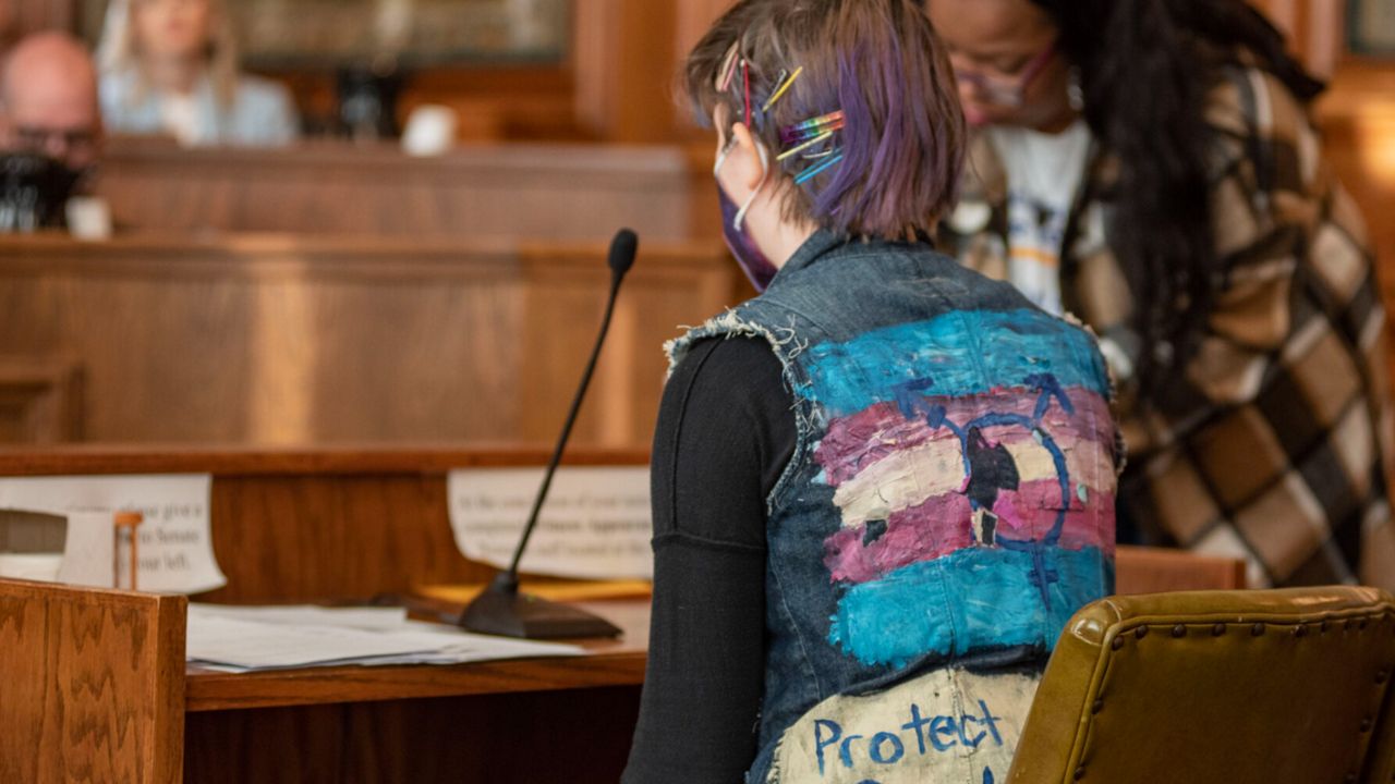 Neon Liebson, a transgender student from St. Louis, says his name into the microphone during a January hearing of the Senate Education and Workforce Development Committee. He and other students who missed school to testify did not get to give their comments, but the committee acknowledged them by allowing them to say their names. (Annelise Hanshaw/Missouri Independent)