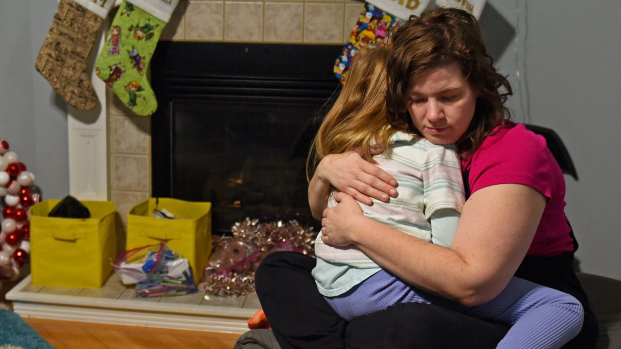 Angela Crawford, 38, hugs her daughter, Alexandria, 6, in their Springfield home on Dec. 14, 2023. “I could not be happier,” said Crawford, who started an infertility support group after undergoing IVF to have her two children. “I’m in the best mental health of my life. And I want what I have for everyone” (Anna Spoerre/Missouri Independent).