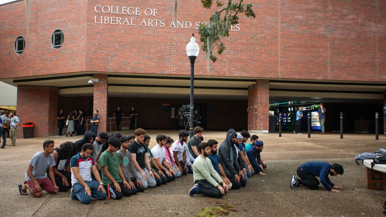 Students gather for prayer at the University of Florida's Turlington Hall after a teach-in organized by the Students for Justice in Palestine to discuss the Israel-Hamas war on Thursday, Oct. 12, 2023, in Gainesville. The DeSantis administration now says the group must be "deactivated" on Florida's public university campuses. (Luis Santana/Times)