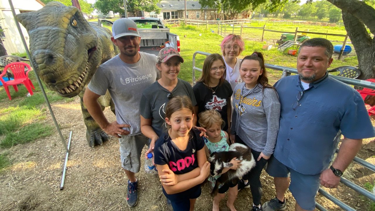 Pictured is the Bird family and friends after a prank involving Norman the dinosaur scaring/surprising a 17-year-old Sophie Bird who has ornithoscelidaphobia (the fear of dinosaurs). (Spectrum News 1/Lupe Zapata)