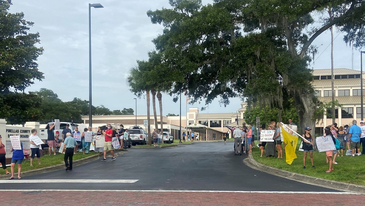 Parents on both sides of the issue of masks in schools gathered outside Tuesday's Pinellas County School Board meeting in Largo to protest. (Spectrum News/Jorja Roman)