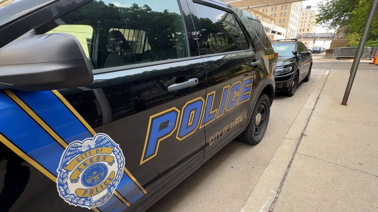 Akron Police vehicle sits on the street in front of APD headquarters 