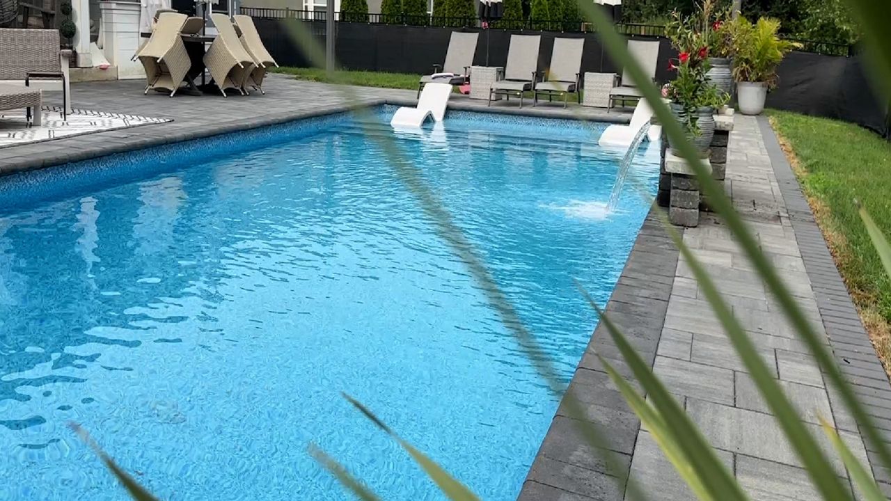 Eric Schoen’s backyard saltwater pool, where he keeps a close eye on water quality for his family’s safety. (Spectrum News 1/Aliah Keller)