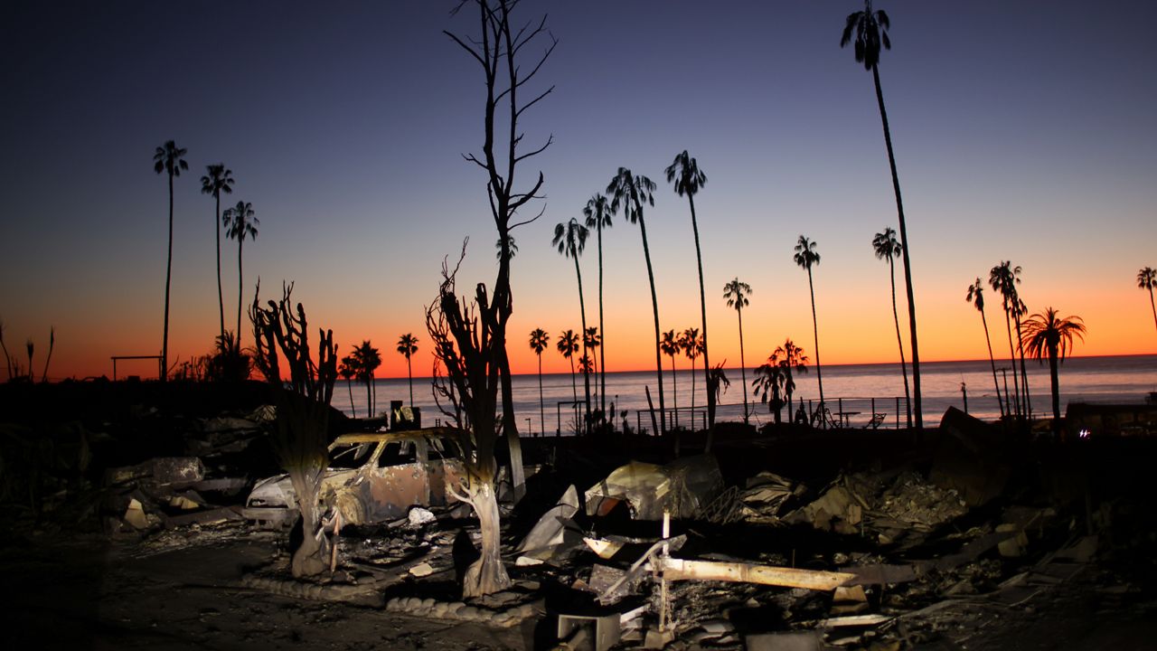 The devastation of the Palisades Fire is seen at sunset in the Pacific Palisades neighborhood of Los Angeles, Tuesday, Jan. 14, 2025. (AP Photo/Ethan Swope)