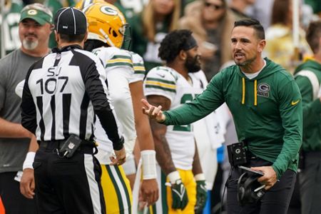 Washington Commanders quarterback Taylor Heinicke (4) throws under pressure  from Green Bay Packers linebacker Rashan Gary (52) during the first half of  an NFL football game Sunday, Oct. 23, 2022, in Landover