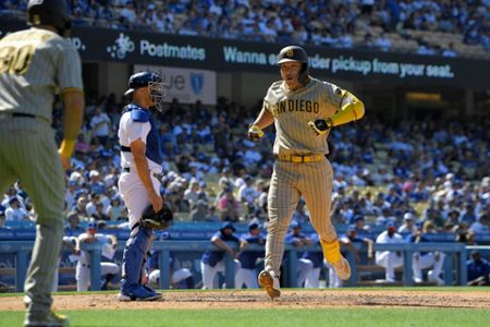 San Diego Padres' Luke Voit scores on a sacrifice fly by Austin