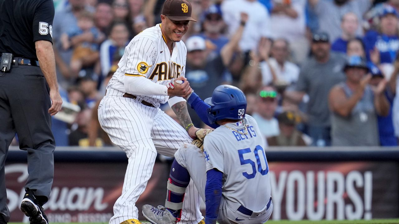 San Diego Padres third baseman Manny Machado, right, walks on the