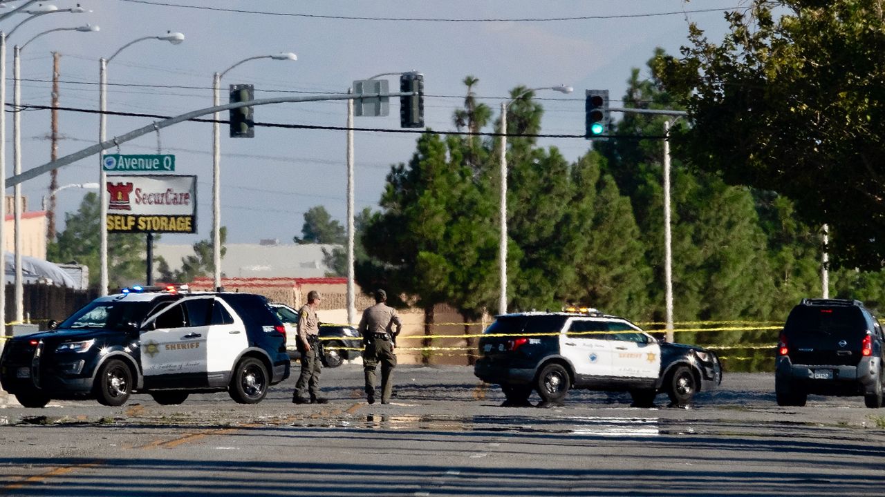 Police cars block off a street where a sheriff's deputy was shot while in his patrol car in Palmdale, Calif. on Sunday, Sept. 17, 2023.  (AP Photo/Richard Vogel)