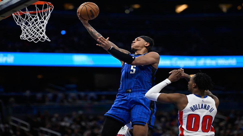 Orlando forward Paolo Banchero goes up for a shot in front of Detroit Pistons forward Ronald Holland II during the second half of Saturday night's game.