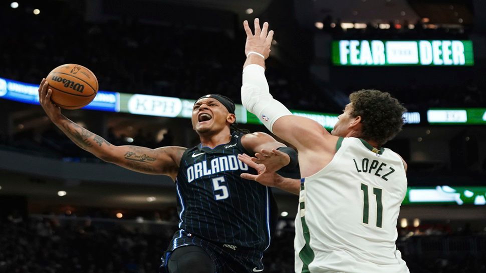 Orlando Magic's Paolo Banchero (5) shoots against Milwaukee Bucks' Brook Lopez (11) during the first half of an NBA basketball game Saturday, March 8, 2025, in Milwaukee. (AP Photo/Aaron Gash)