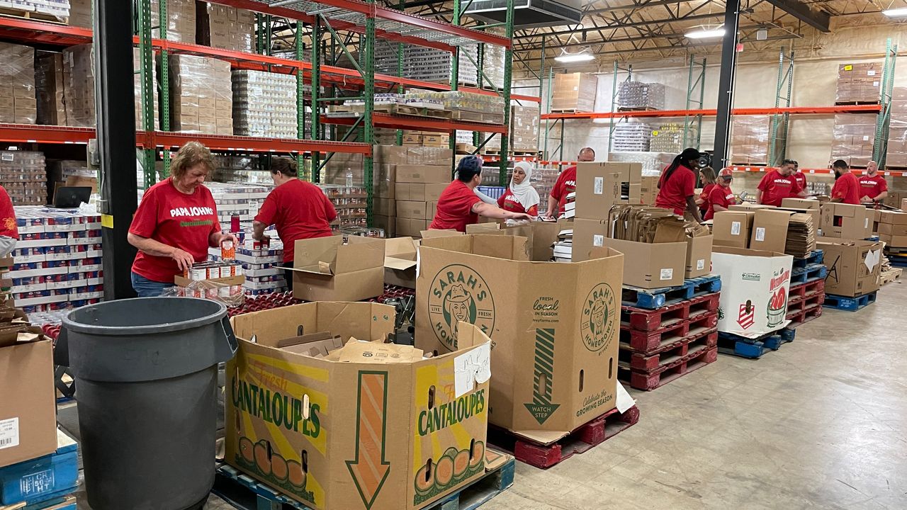 Papa Johns staff packing meal boxes at a Dare to Care warehouse (Spectrum News 1/Mason Brighton)