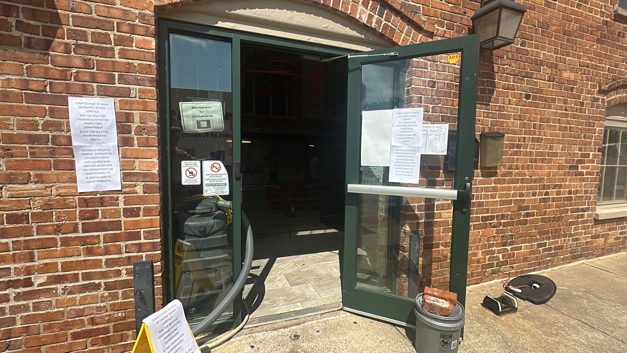 Notices on a building that had flooded Thursday told Sanford residents that services would not be available Friday. (Spectrum News 1/Patrick Thomas)