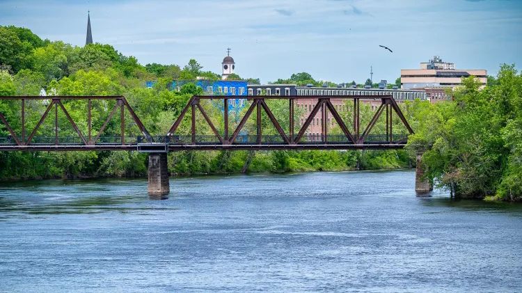 The John T. Jenkins Memorial Bridge is seen Thursday over the Androscoggin River between Lewiston and Auburn. Advocates are pushing for a section of the river to be reclassified to reflect its improved water quality, a move they say would be good for residents and the regional economy. (Russ Dillingham/Sun Journal)	