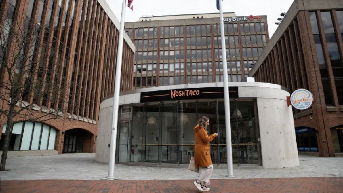 A pedestrian passes Canal Plaza in Portland on Wednesday, where a group is planning to build Maine’s tallest building. (Portland Press Herald/Derek Davis)
