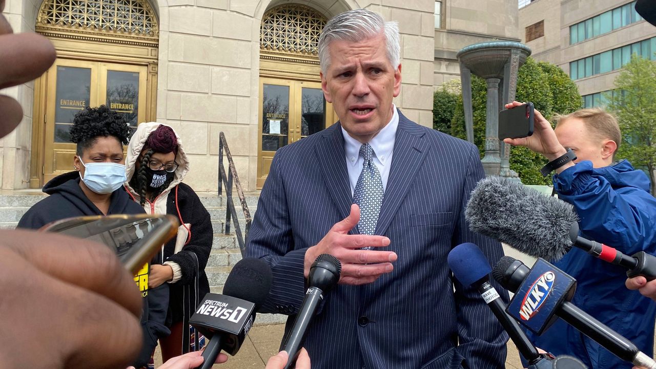Attorney Patrick Renn answers questions from reporters outside the Gene Snyder United States Courthouse in Louisville, Ky., Friday, April 8, 2022. His client Quintez Brown pled not guilty to federal charges in U.S. District Court. (AP Photo/Piper Hudspeth Blackburn)