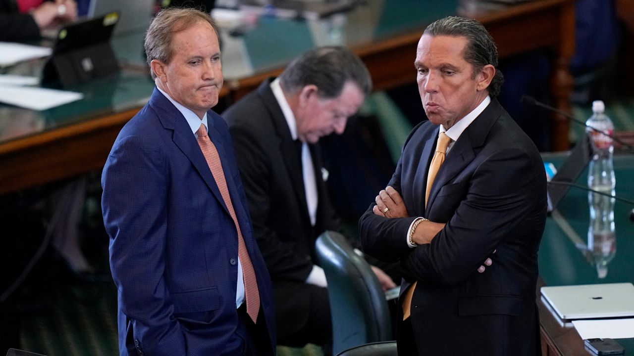Texas state Attorney General Ken Paxton, left, stands with his attorney Tony Buzbee, right, before his impeachment trial in the Senate Chamber at the Texas Capitol, Tuesday, Sept. 5, 2023, in Austin, Texas. (AP Photo/Eric Gay)