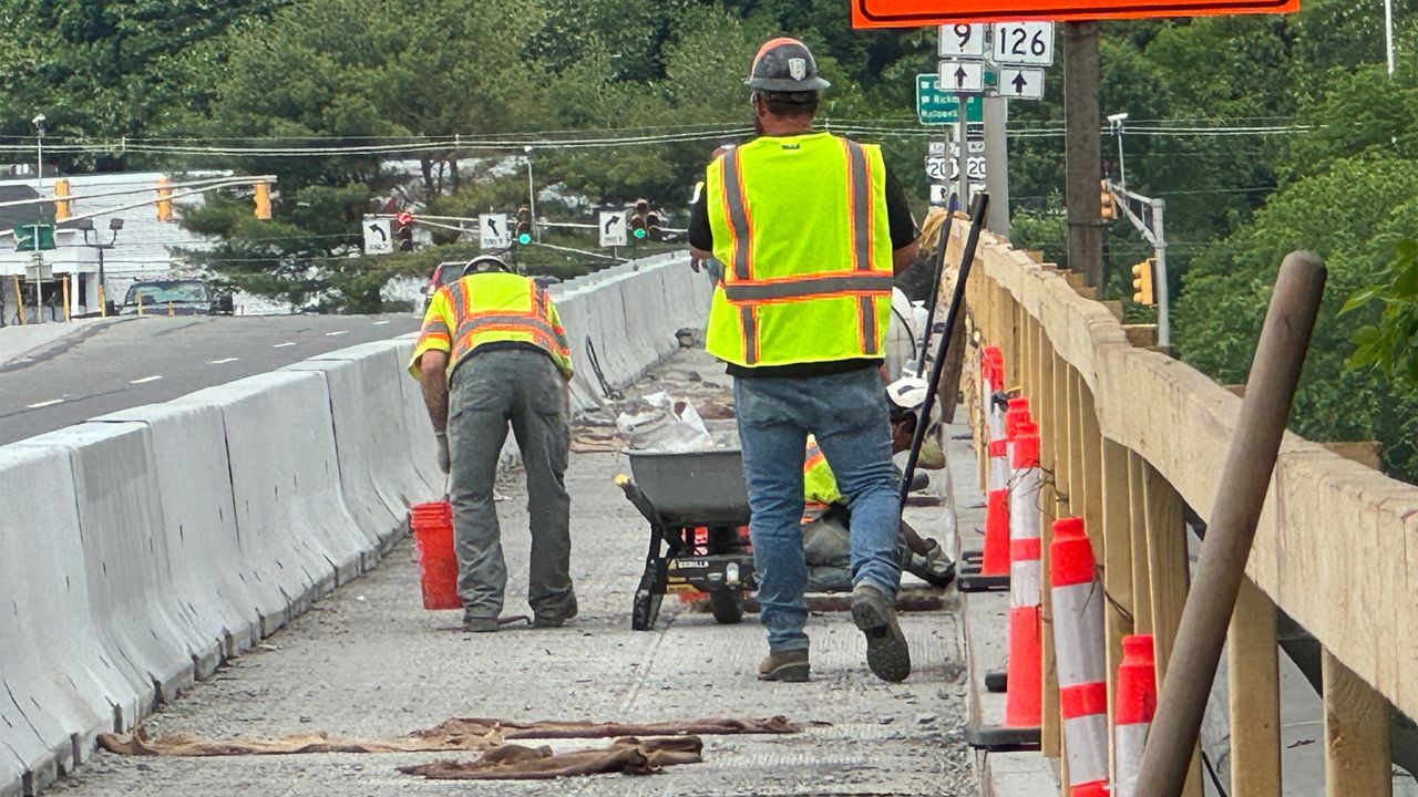 Crews on Thursday work on the Pearl Harbor Remembrance Bridge spanning the Kennebec River between Gardiner and Randolph. (Matthew Jaroncyk/Spectrum News)