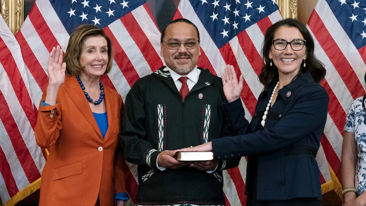 Speaker of the House Nancy Pelosi of Calif., left, administers the House oath of office to Rep. Mary Peltola, D-Alaska, standing next to her husband Eugene "Buzzy" Peltola Jr., center, during a ceremonial swearing-in on Capitol Hill in Washington, Tuesday, Sept. 13, 2022. Peltola's husband Eugene has died in an airplane crash in Alaska, her office said Wednesday, Sept. 13, 2023. ( AP Photo/Jose Luis Magana, File)